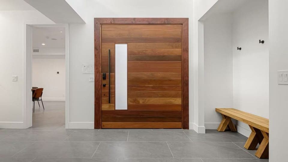 Grand custom pivot entry door crafted from rich hardwood, welcoming you into a world of contemporary luxury.