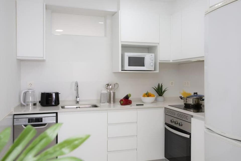 Kitchen or kitchenette, dishwasher, microwave, oven, stove, toaster