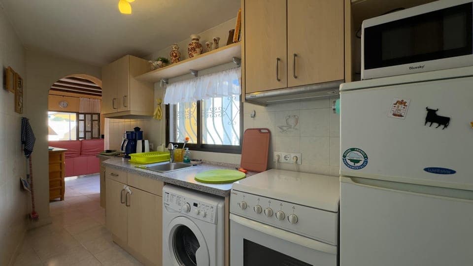 Kitchen or kitchenette, stove, washing machine