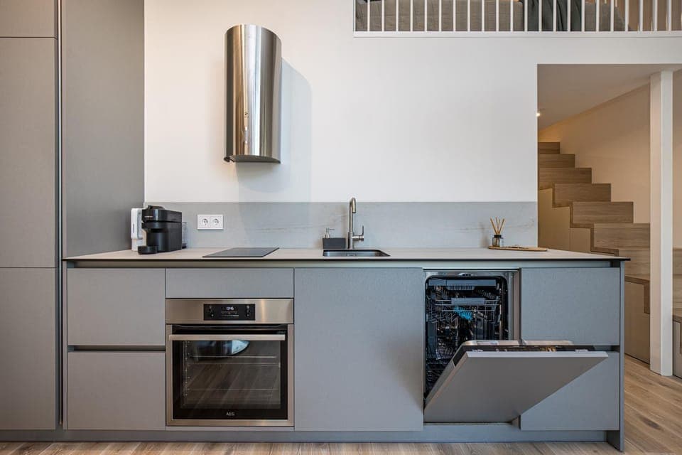 Kitchen or kitchenette, dishwasher, oven, stove