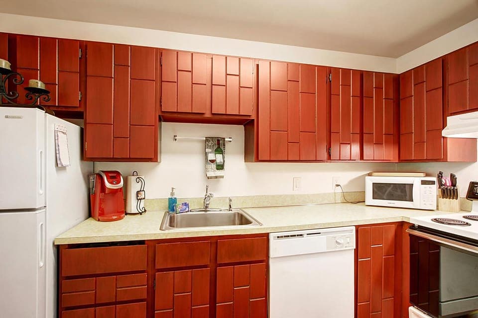 Kitchen or kitchenette, dishwasher, oven, stove