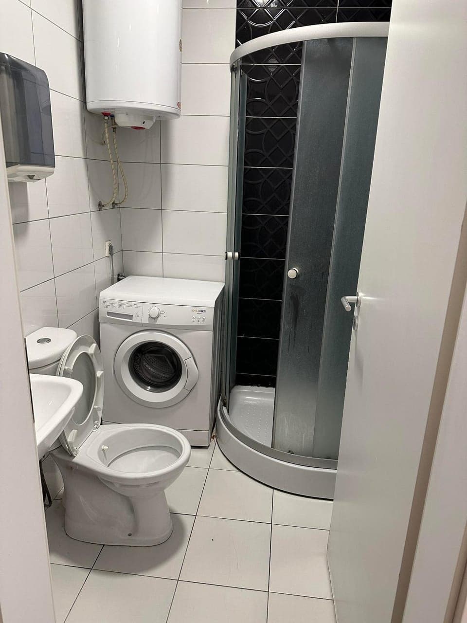 Shower, Toilet, Bathroom, hair dryier, towels, washing machine