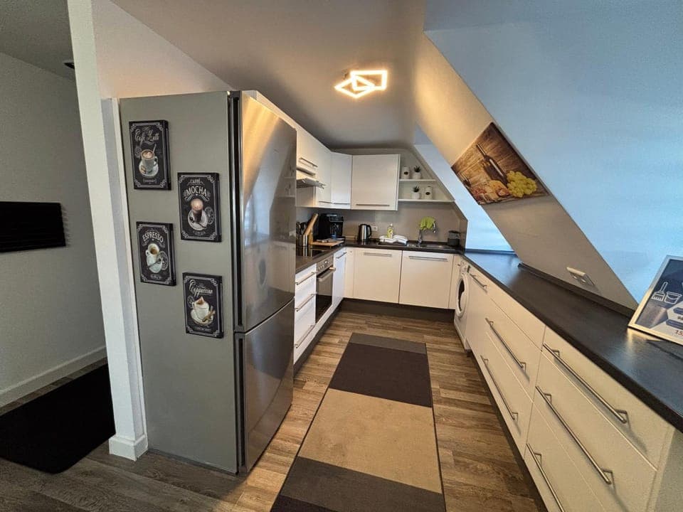 Kitchen or kitchenette, dishwasher, oven, stove