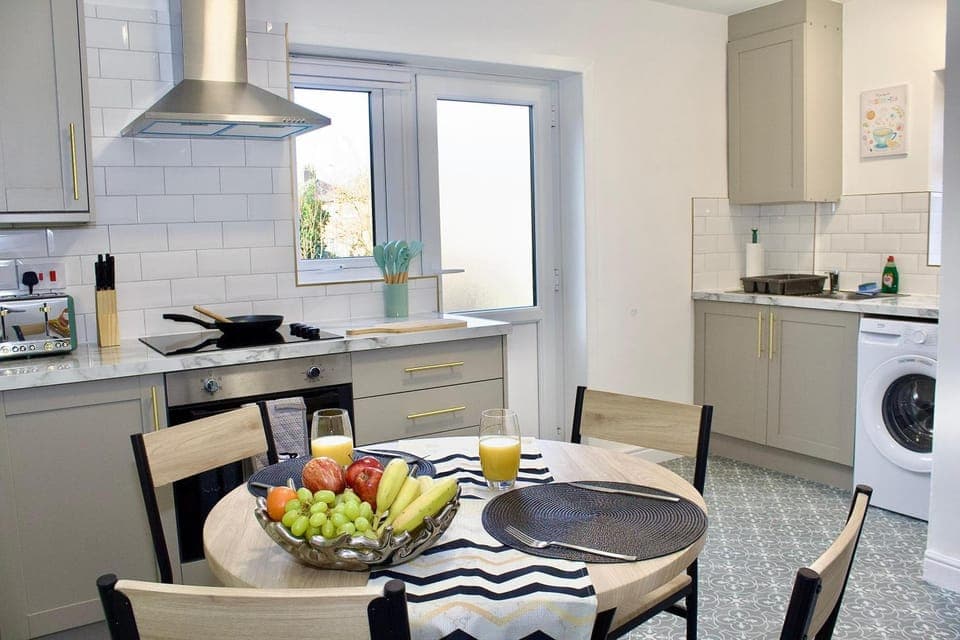 Kitchen or kitchenette, Seating area, Dining area, oven, stove, toaster, washing machine