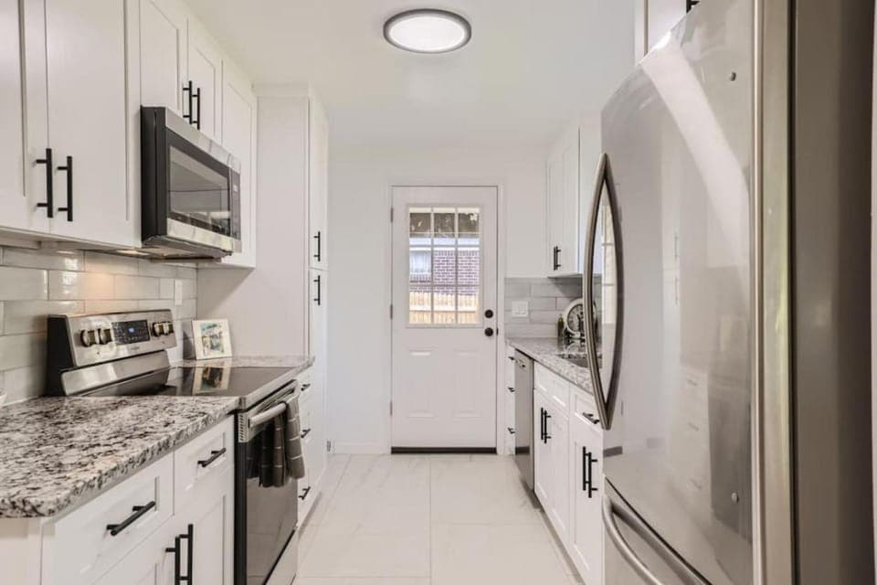 Kitchen or kitchenette, dishwasher, microwave, oven, stove