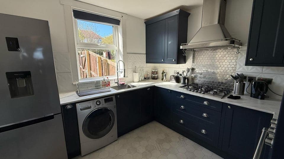 Kitchen or kitchenette, microwave, oven, stove, toaster, washing machine