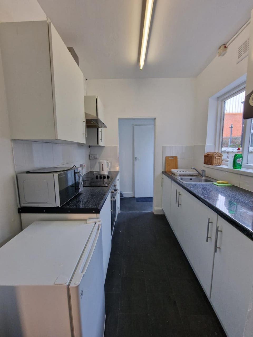 Kitchen or kitchenette, dishwasher, oven, stove