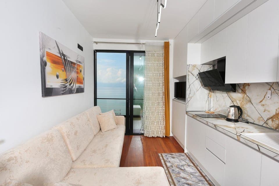 People, TV and multimedia, Kitchen or kitchenette, Living room, Seating area, Sea view, Sea view, furniture, furniture, minibar, oven