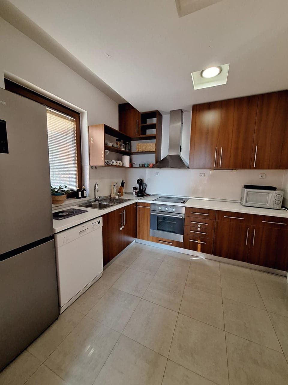 Kitchen or kitchenette, dishwasher, oven, stove