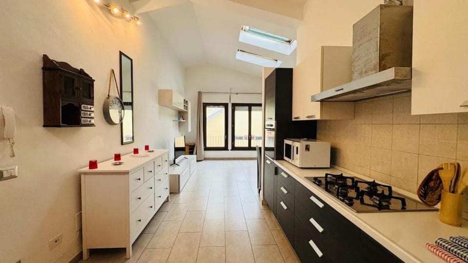 Kitchen or kitchenette, dishwasher, oven, stove