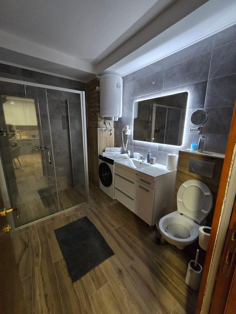 Shower, Toilet, Bathroom, hair dryier, towels, washing machine