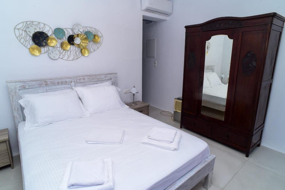 Bed, towels, wardrobe