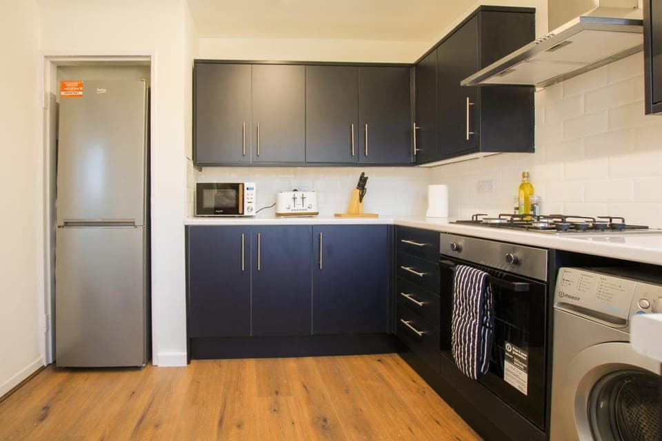 Kitchen or kitchenette, oven, stove, toaster, washing machine, dryer