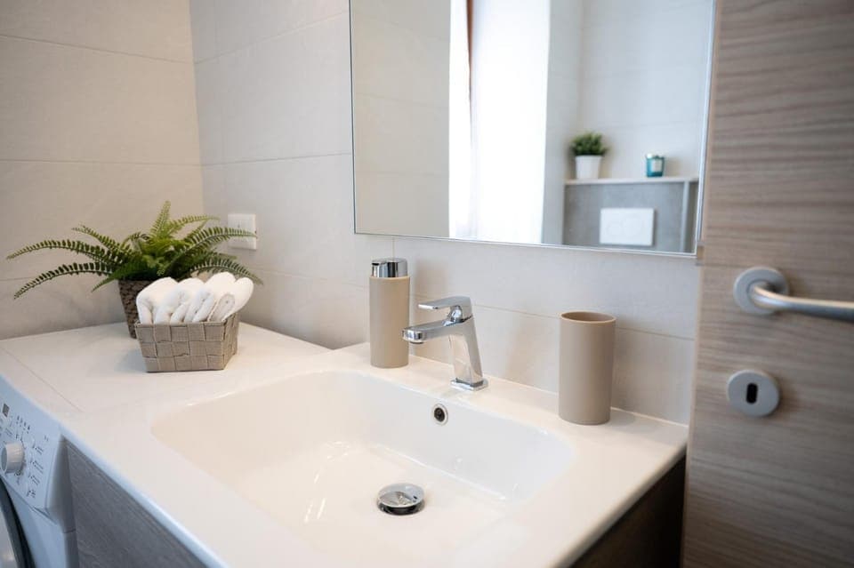 Bathroom, hair dryier, towels, washing machine