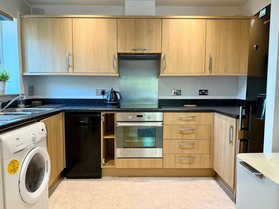 Kitchen or kitchenette, dishwasher, oven, stove