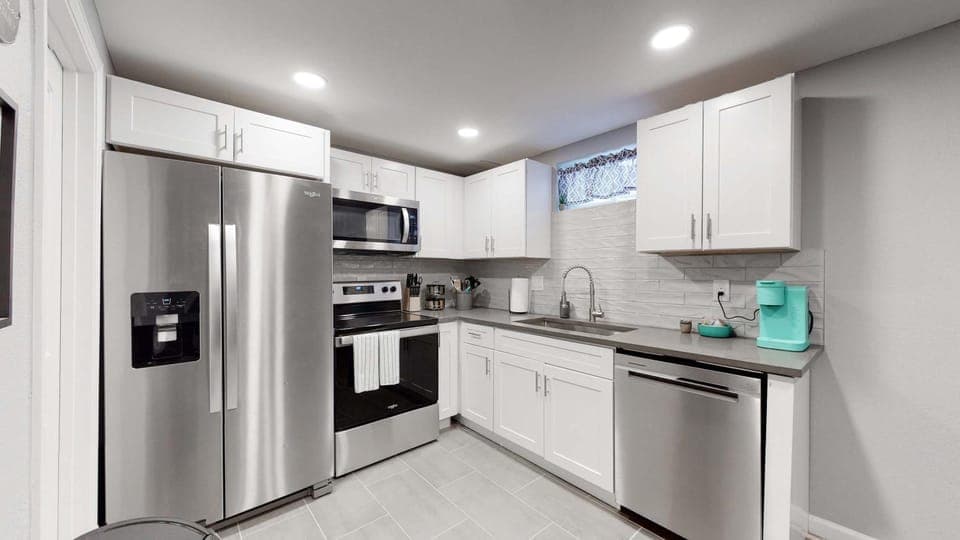 Kitchen or kitchenette, dishwasher, microwave, oven, stove