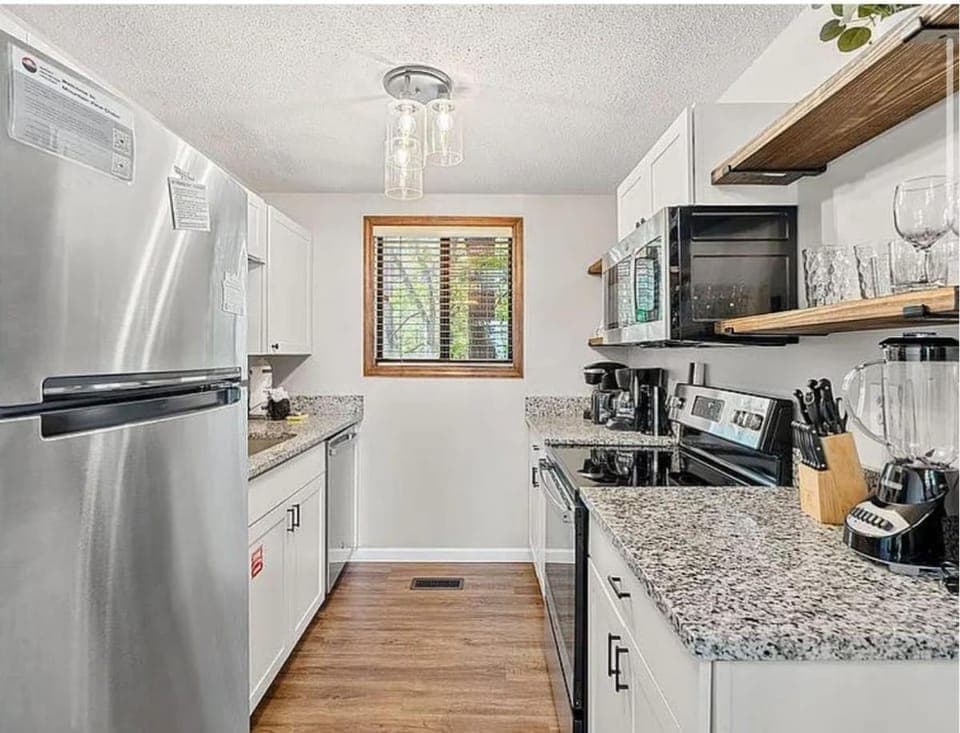 Kitchen or kitchenette, dishwasher, oven, stove