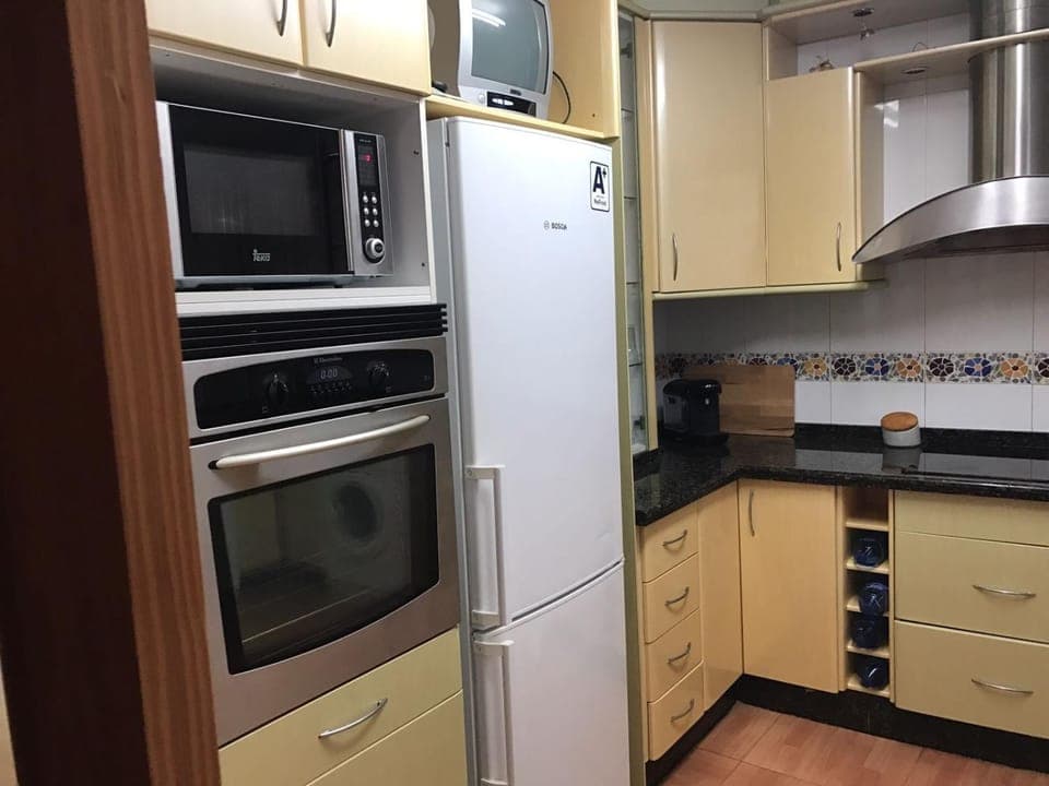 Kitchen or kitchenette, dishwasher, oven, stove