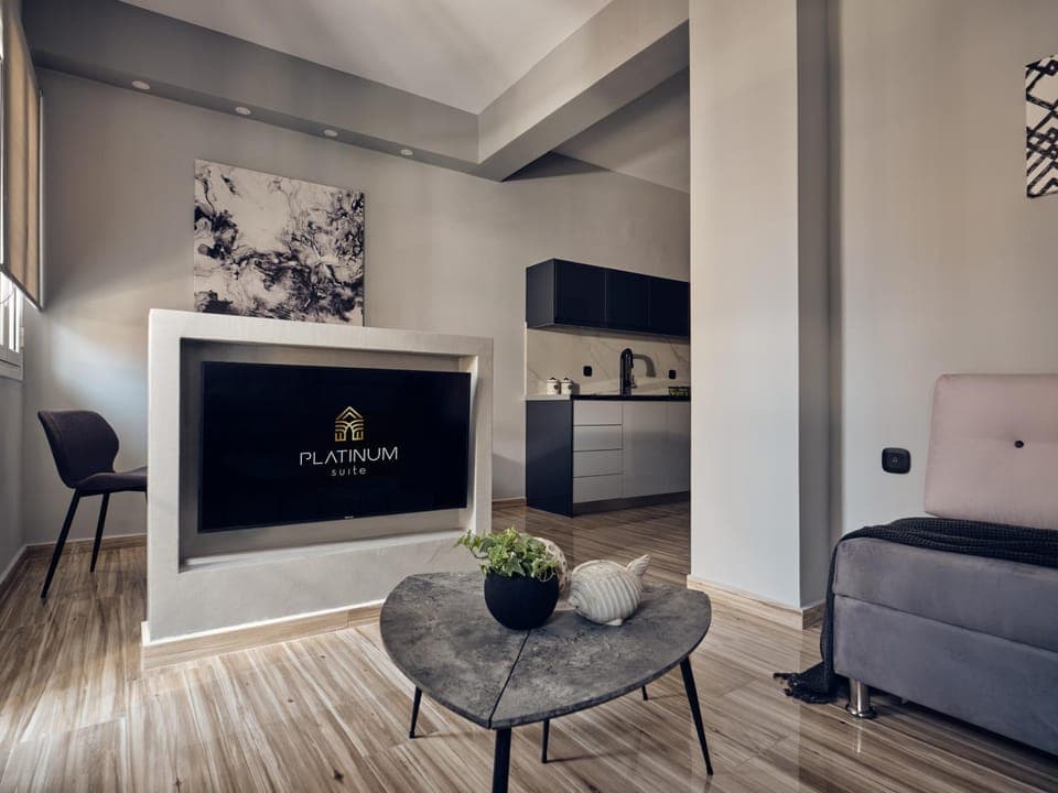 Property logo or sign, TV and multimedia, Kitchen or kitchenette, Living room, Dining area