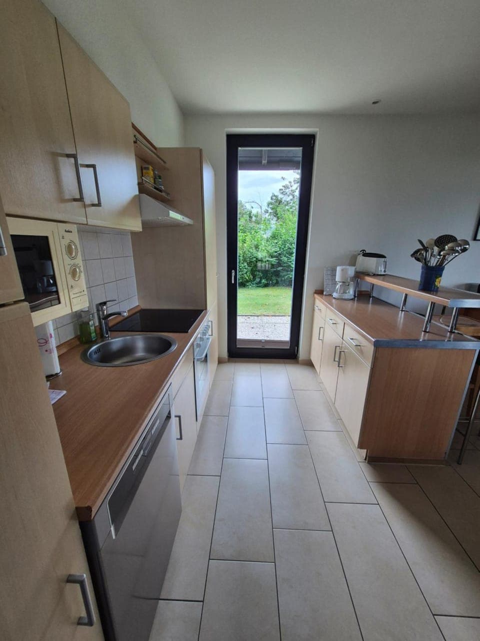 Kitchen or kitchenette, dishwasher, microwave, stove, toaster