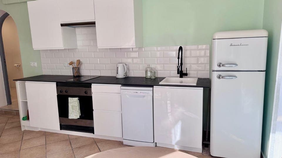 Kitchen or kitchenette, dishwasher, oven, stove
