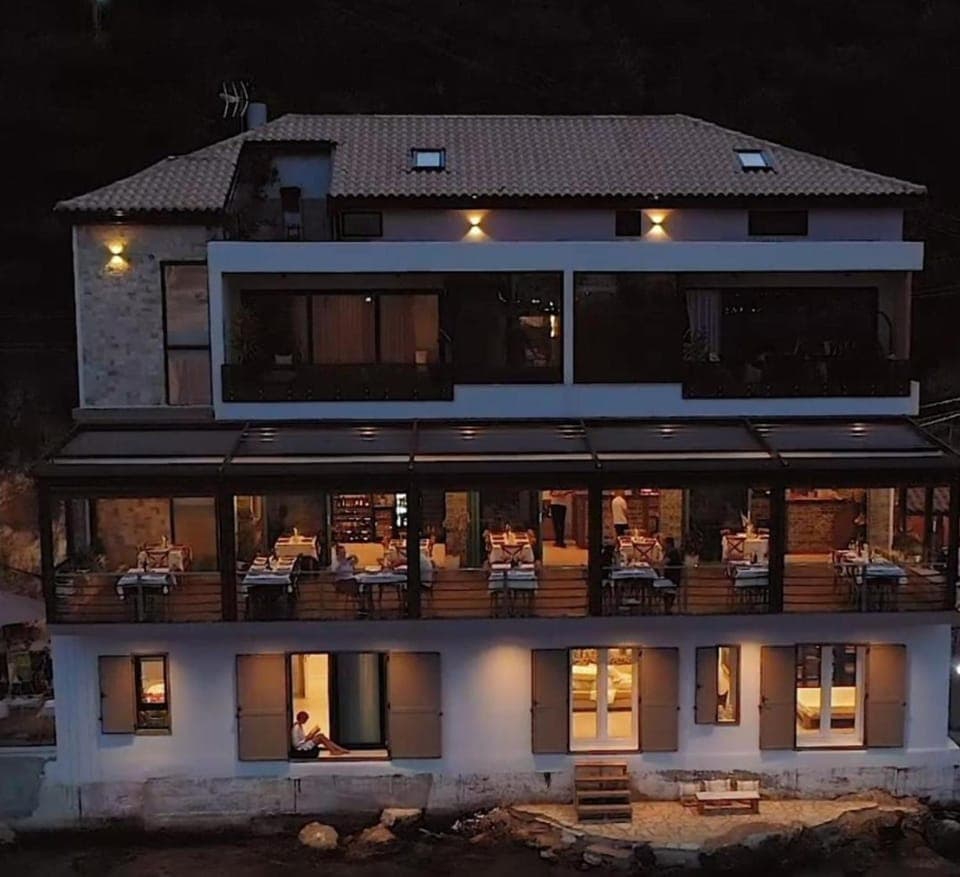 Property building, Patio, Night, People, View (from property/room), Balcony/Terrace, Living room, Seating area, group of guests