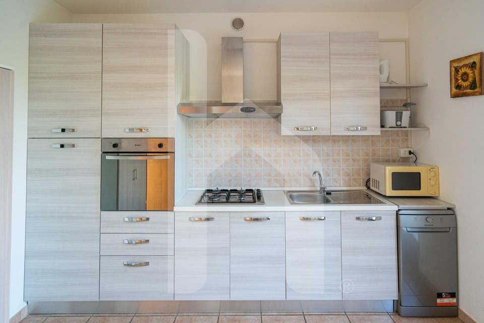 Kitchen or kitchenette, dishwasher, oven, stove