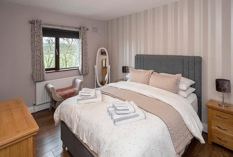 Bed, Bathroom, hair dryier, towels, wardrobe