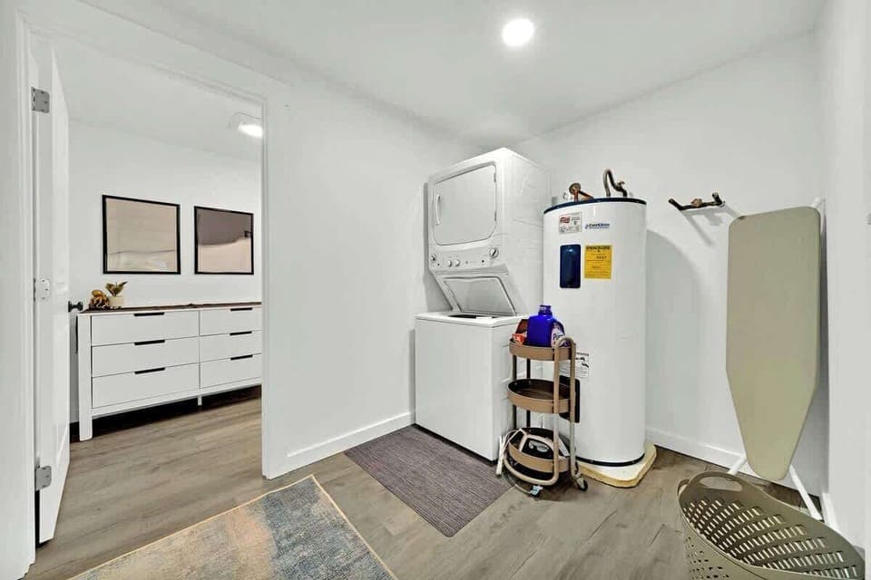 The stackable washer/dryer just off from the 2nd living room leads into the half bathroom that services the middle floor.