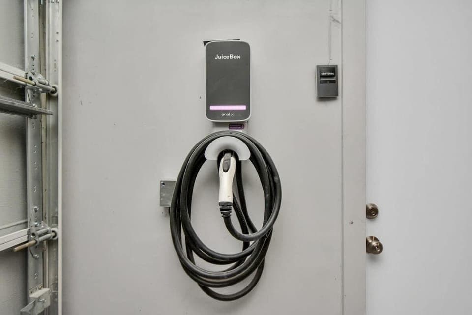 This electric vehicle (EV) charger is a Level 2 charger which requires a 240-volt AC connection. 
It offer faster charging speeds, typically adding around 20 to 30 miles of range per hour.
This is located inside the garage for your convenience.