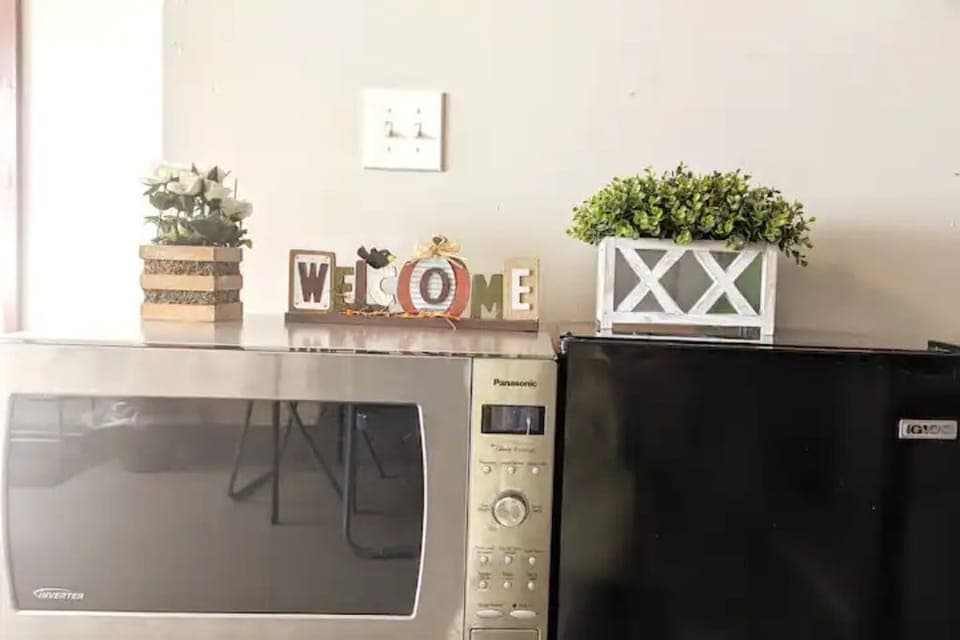 Microwave and mini fridge in private living room.