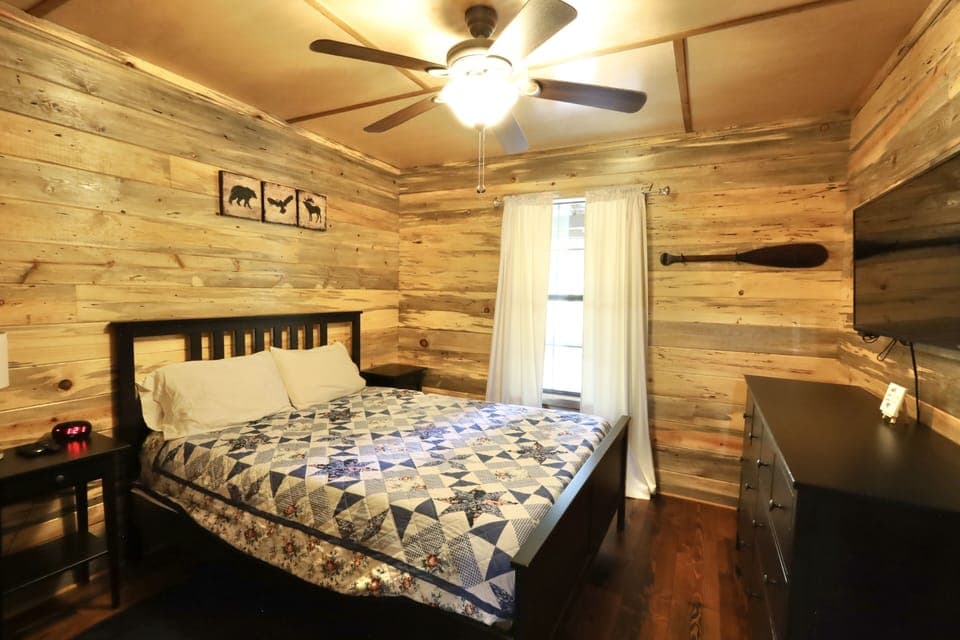 Bedroom #3 with queen bed and tv.