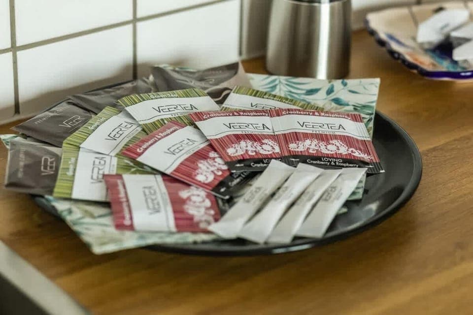 Close-up of a tray filled with coffee and tea prepared for a guest's arrival.
