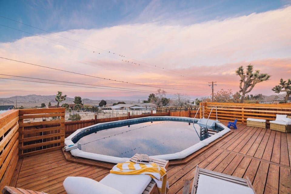 Sunset over the pool with mountain views and joshua trees