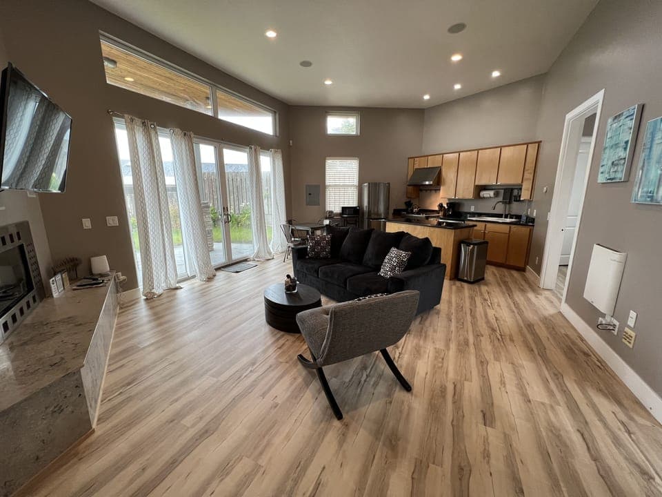 Living room and kitchen from front door  Lots of light and patio.