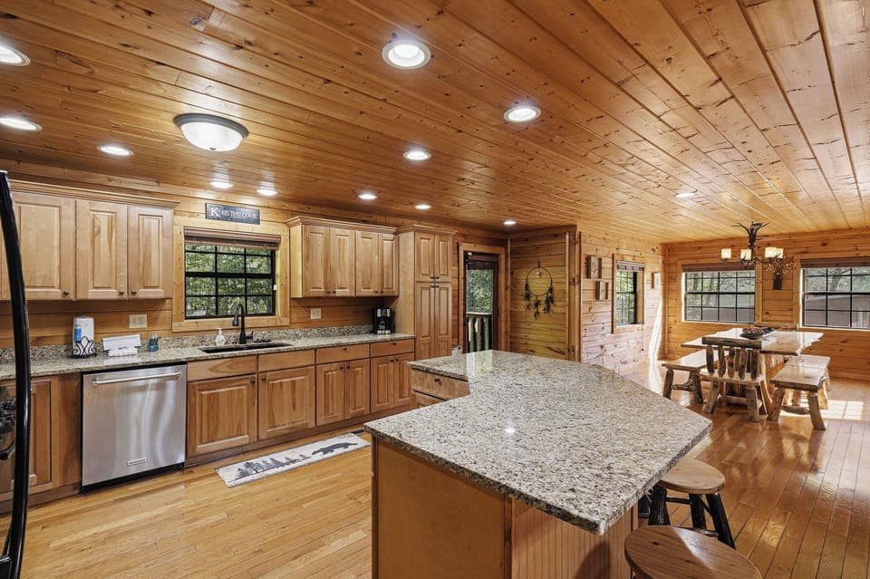 Your fully-equipped kitchen invites mountain cooking adventures with granite counters, modern appliances, and rustic wood charm throughout.