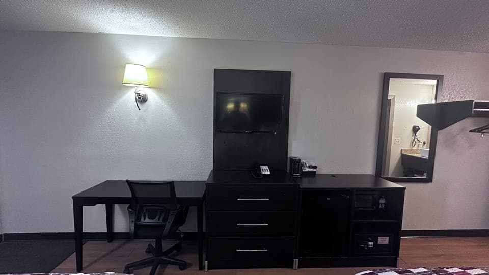 Desk, laptop workspace, blackout drapes, iron/ironing board