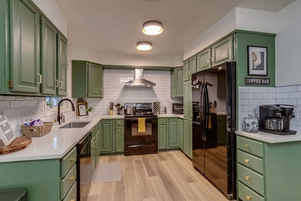 Fully equipped kitchen with KitchenAid mixer, coffee maker, and cookware for large groups