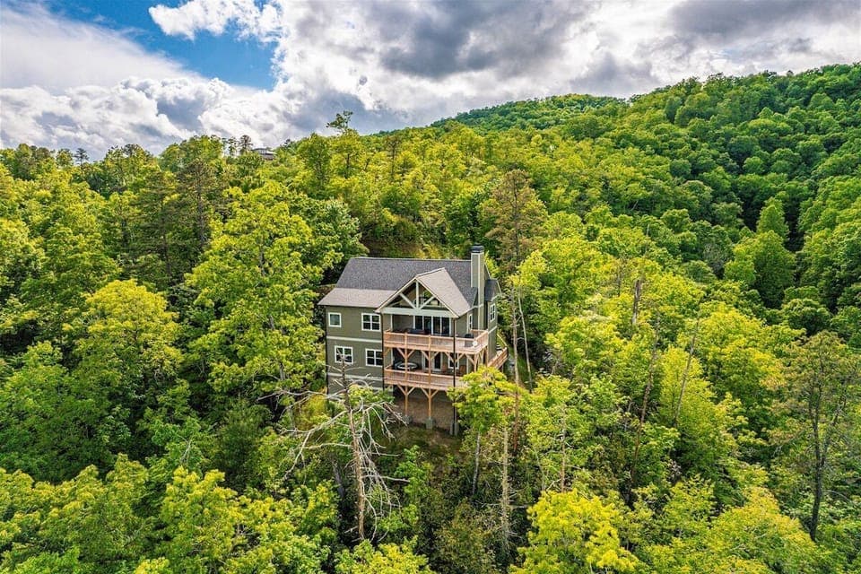 Aerial view of Fontana Grace nestled among lush trees in Bryson City, offering privacy and luxury with scenic surroundings.