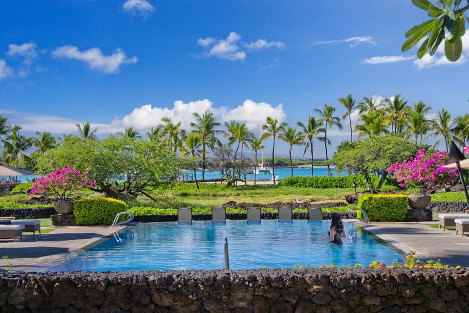 The best condo pool with a view on the island! The beach club includes a negative edge pool, a shallow sandy pool, resort style jacuzzi, shaded seating, gazebos, a fitness center, bathrooms, changing rooms, outdoor showers, towel service, views of A-Bay a