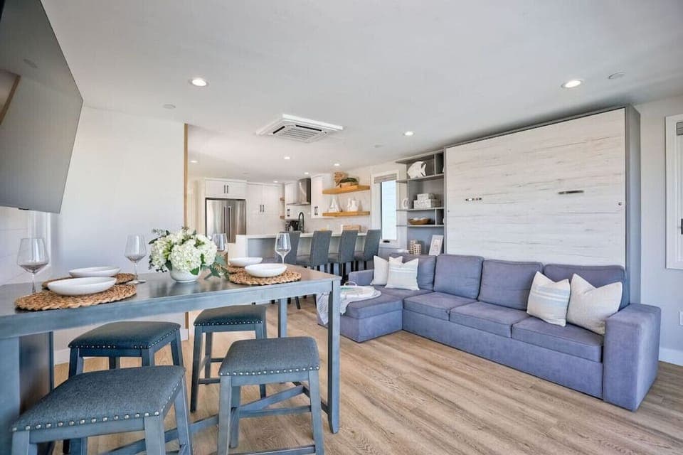 DINING AREA WITH TABLE FOR FOUR & KITCHEN BAR SEATING – This comfortable dining space features a table for four plus additional seating at the kitchen counter barstools, making it perfect for family meals, casual dining, and gathering together in this Mis