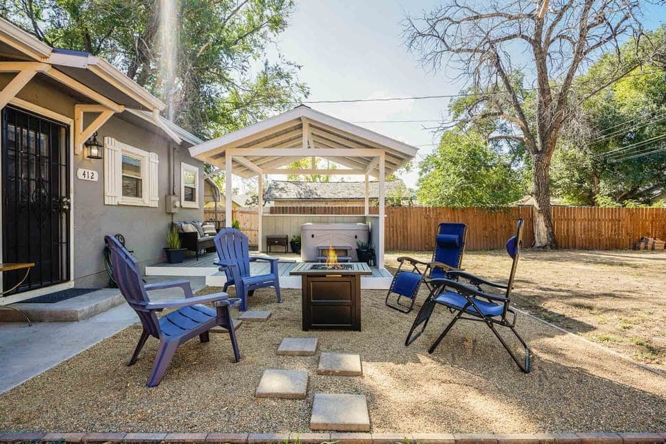 Hot tub and firepit in the fenced backyard