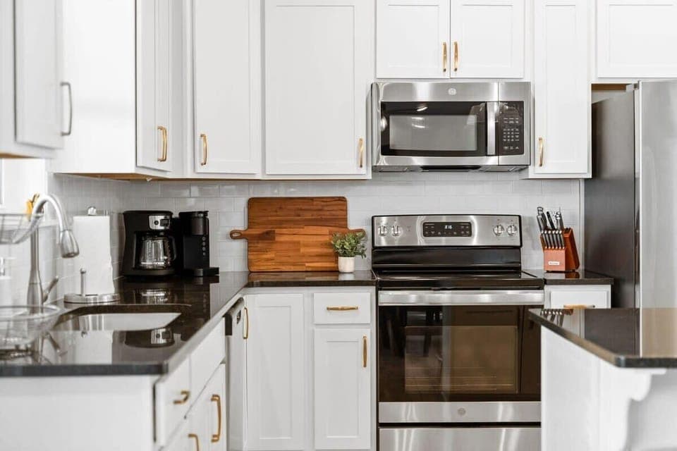 This modern kitchen is adorned with stainless steel appliances and everything you need for the perfect stay!