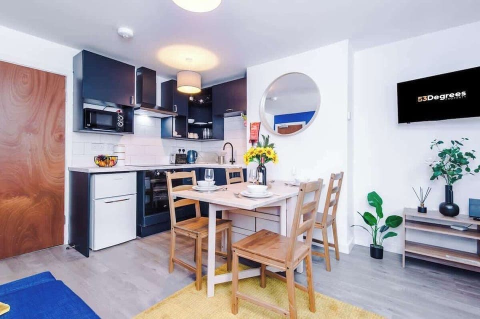 The open plan living room benefits from a double sofa bed, 4 seater dining table and fully equipped kitchen.