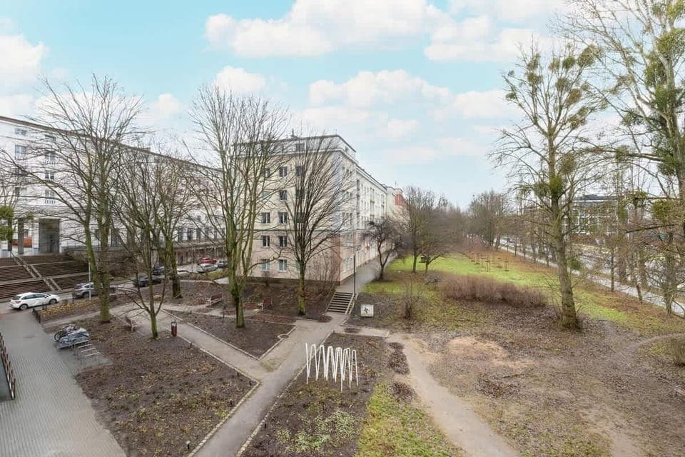 Courtyard area with benches, trees, and garden paths, promoting relaxation and outdoor enjoyment.
