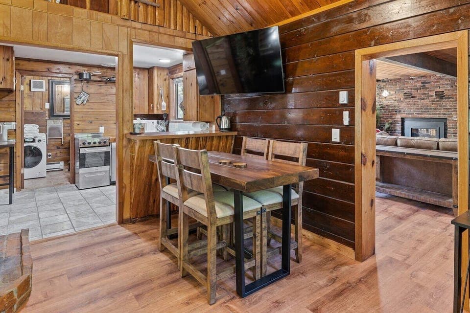 Dining and lounging area with huge 65" TV close to the kitchen.