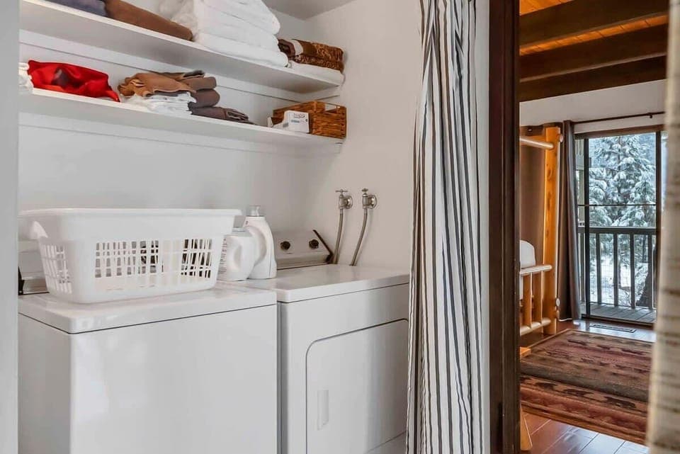 A laundry closet with a full-size washer and dryer is located in the hallway near the downstairs bedrooms so you can keep up with any laundry needs during your stay.