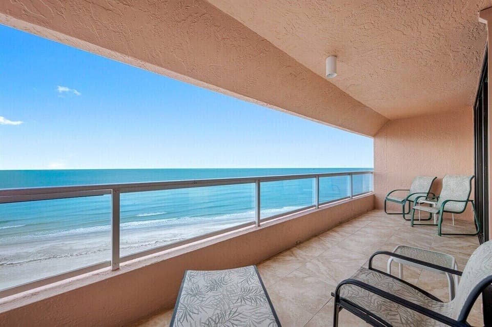 Expansive balcony with furniture overlooking the aqua waters of Gulf of Mexico
