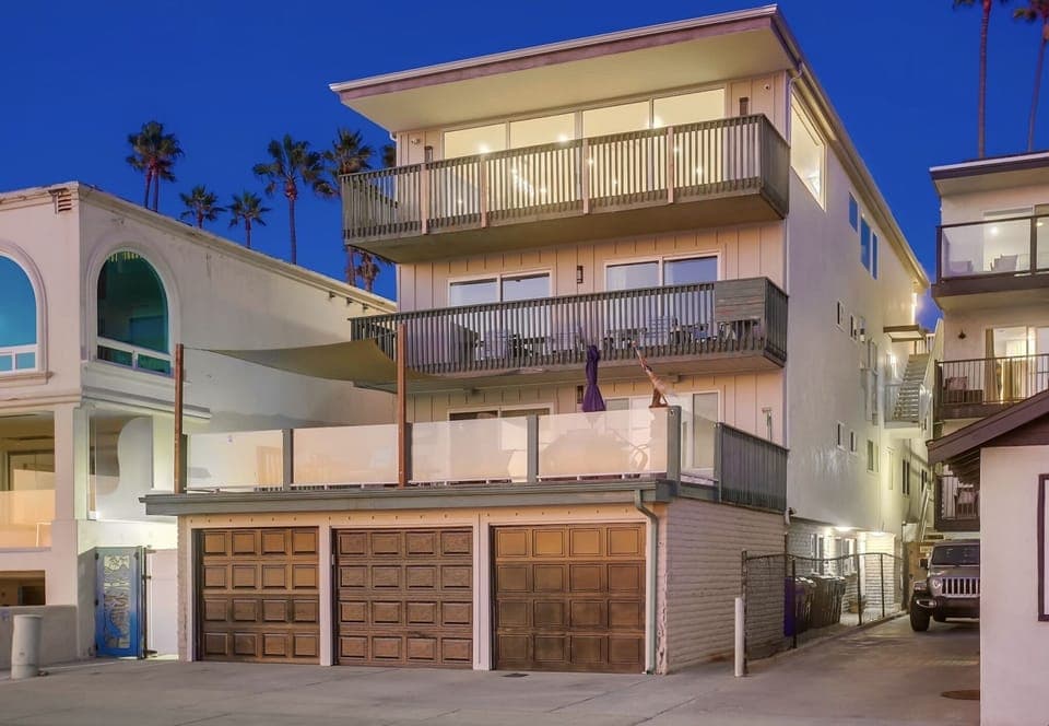 Rear of home facing strand - our garage in middle spot.