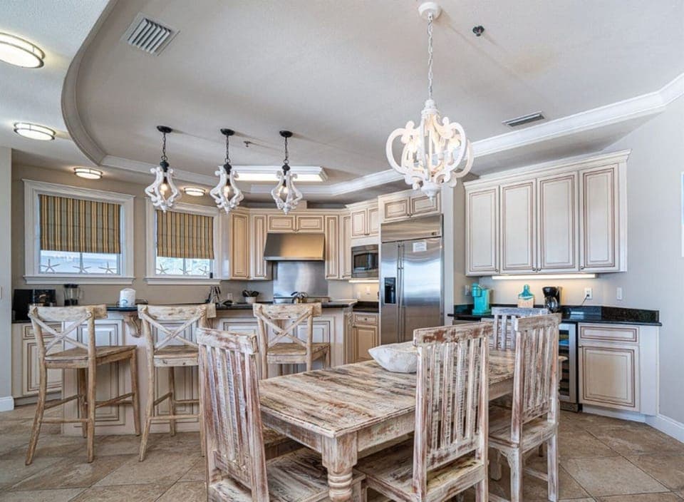 Your gourmet kitchen welcomes you with granite counters, elegant pendant lighting, and a rustic dining table perfect for sharing meals.